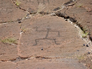 A Standing Figure from Puako Petroglyph Field; Many Authorities Believe the Raised Right Hand Signifies the Hawaiian Primary Geographic Direction We Call "North-west": Photo by Donnie MacGowan