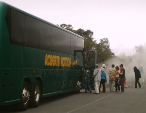 Tourists Load Aboard a Large Motor Coach for a Tour of Hawaii Volcanoes National Park: Photo by Donnie MacGowan