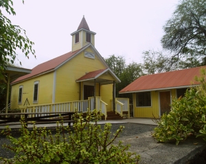 The Hike to Honomalino Beach Starts between the County Park Restrooms and this Yellow Church: Photo by Donald MacGowan